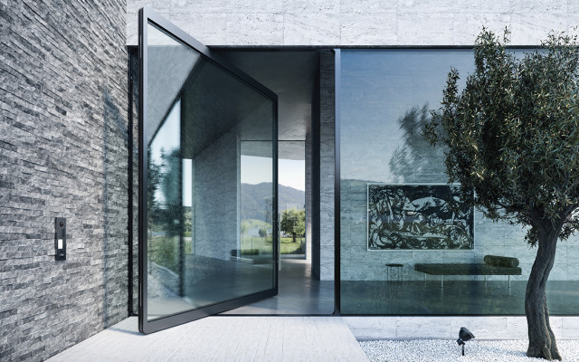 Large contemporary glass pivot door in a modern home